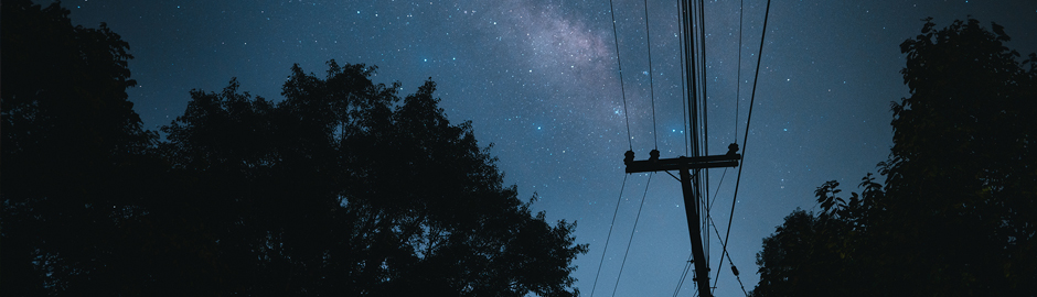 dark sky with bright stars and electric lines